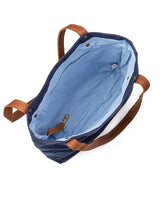 A durable, blue waxed canvas Allagash River Tote Bag with tan handles by Tradevia.