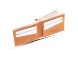 A Heritage Wallet in Baseball Glove Leather by Tradevia with money in it, made in the USA.