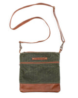 A green waxed canvas Ellis River crossbody bag with brown cowhide straps by Tradevia.