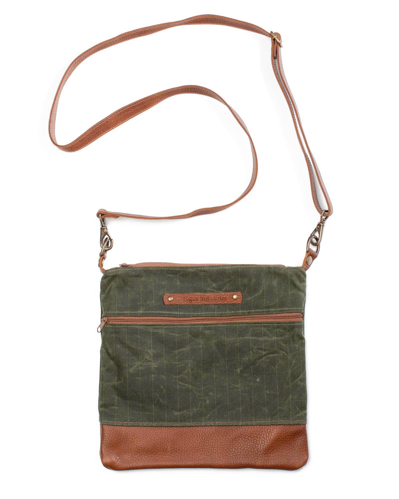 A green waxed canvas Ellis River crossbody bag with brown cowhide straps by Tradevia.