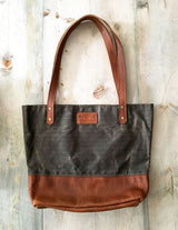 A brown and black Tradevia Saco River Tote Bag.