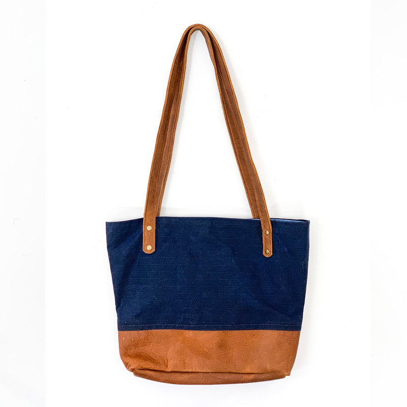 A blue and tan Tradevia Saco River Tote Bag on a white background.