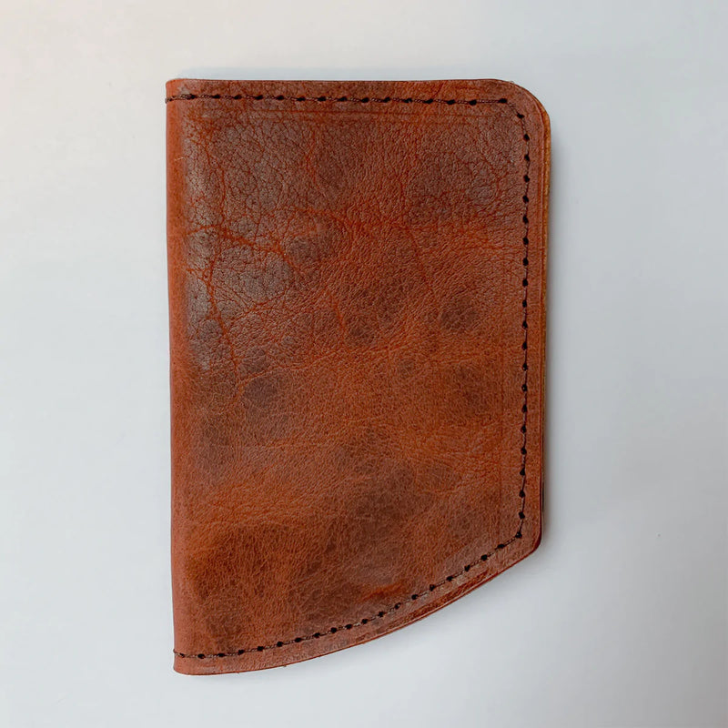 A Tradevia Chamberlain Belt and Minimalist Wallet Bundle in brown leather on a white surface.