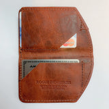 A minimalist brown leather Chamberlain Belt and Minimalist Wallet Bundle with a credit card inside by Tradevia.