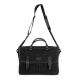 A durable black leather Tradevia briefcase with two straps and a leather handle.