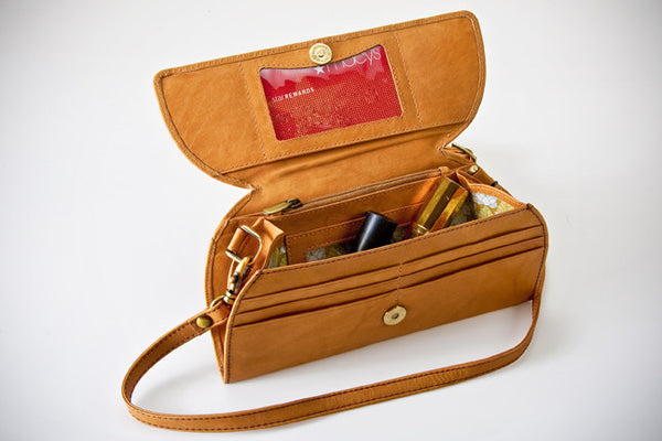 A brown leather RFID Blocking Clutch - Ostrich Print with a red card and a red plastic card inside by Tradevia.